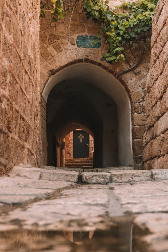 stone street with a door with a cross at the end of it in Jaffa Tel Aviv